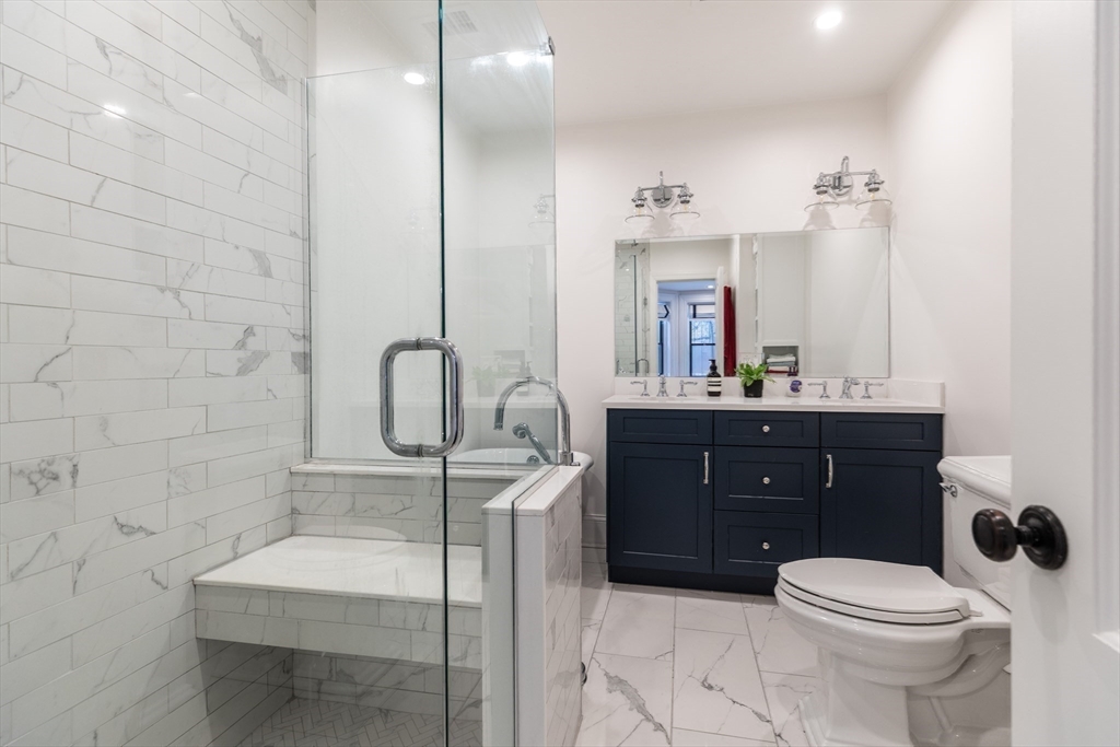 23 Braddock Park, Unit 2 Boston, MA 02116 - Photo 14 of 22 a bathroom with a sink a toilet and mirror