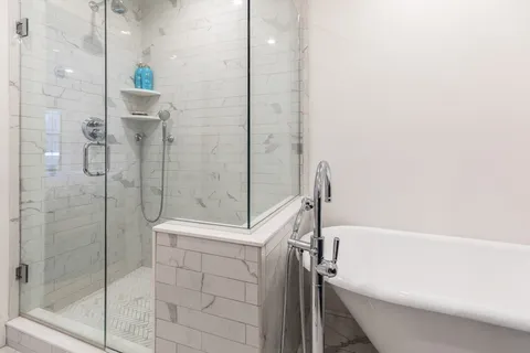 a bathroom with a bathtub and a shower