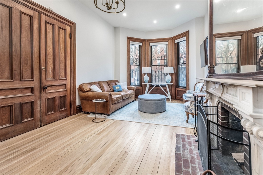 23 Braddock Park, Unit 2 Boston, MA 02116 - Photo 2 of 22 a living room with furniture a fireplace and large window