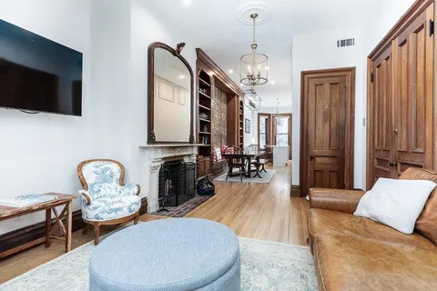 a living room with fireplace furniture and a flat screen tv