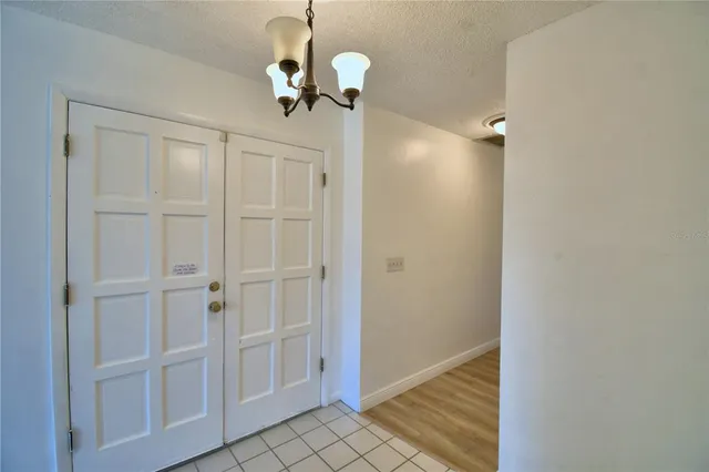a view of a room with wooden floor staircase and a ceiling fan