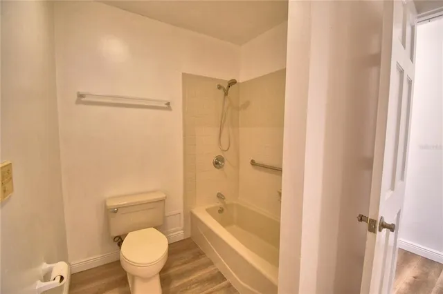a spacious bathroom with a granite countertop sink a mirror and a shower
