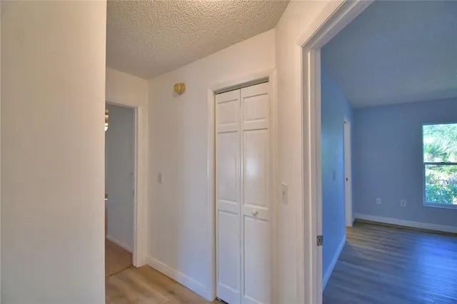 an empty room with a window and a fan