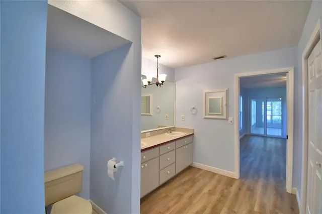 a large kitchen with a counter space a sink appliances and cabinets