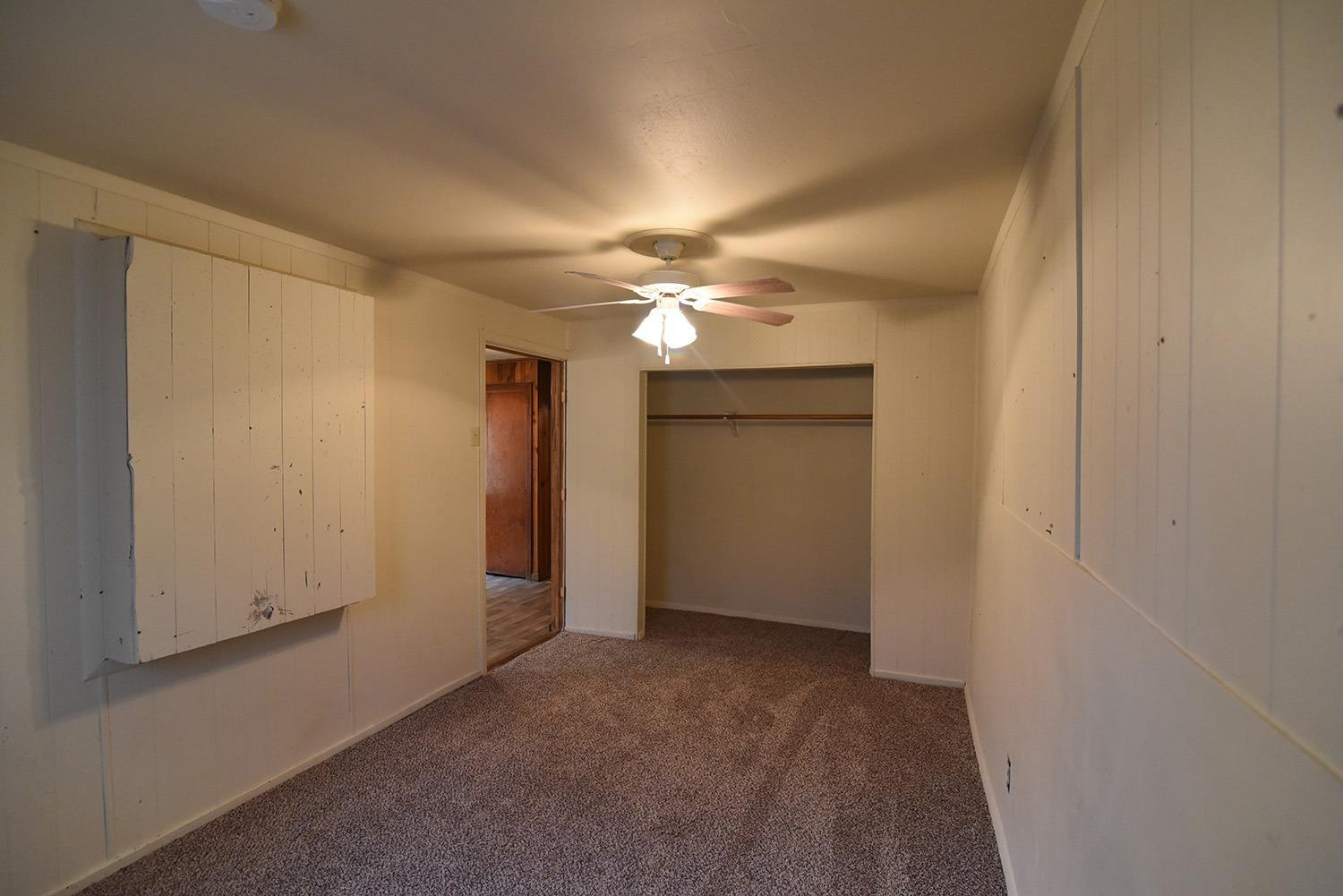 2006 29th Street, Unit REAR Lubbock, TX 79411 - Photo 4 of 10 a view of a livingroom with a ceiling fan and window