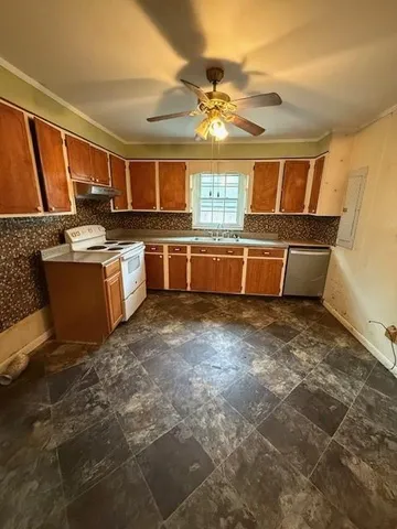 a view of kitchen with sink microwave and cabinets
