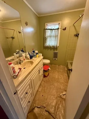 a bathroom with a sink mirror vanity and toilet