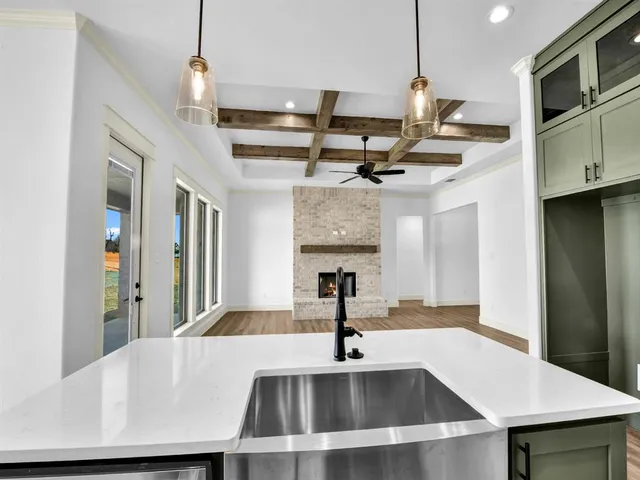 a kitchen with stainless steel appliances granite countertop a sink a microwave oven and a refrigerator