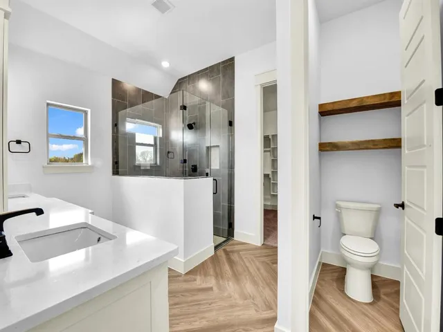 a view of a bathroom with a sink and a mirror