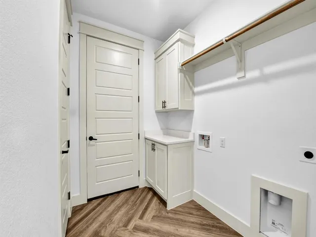 a view of walk in closet with wooden floor