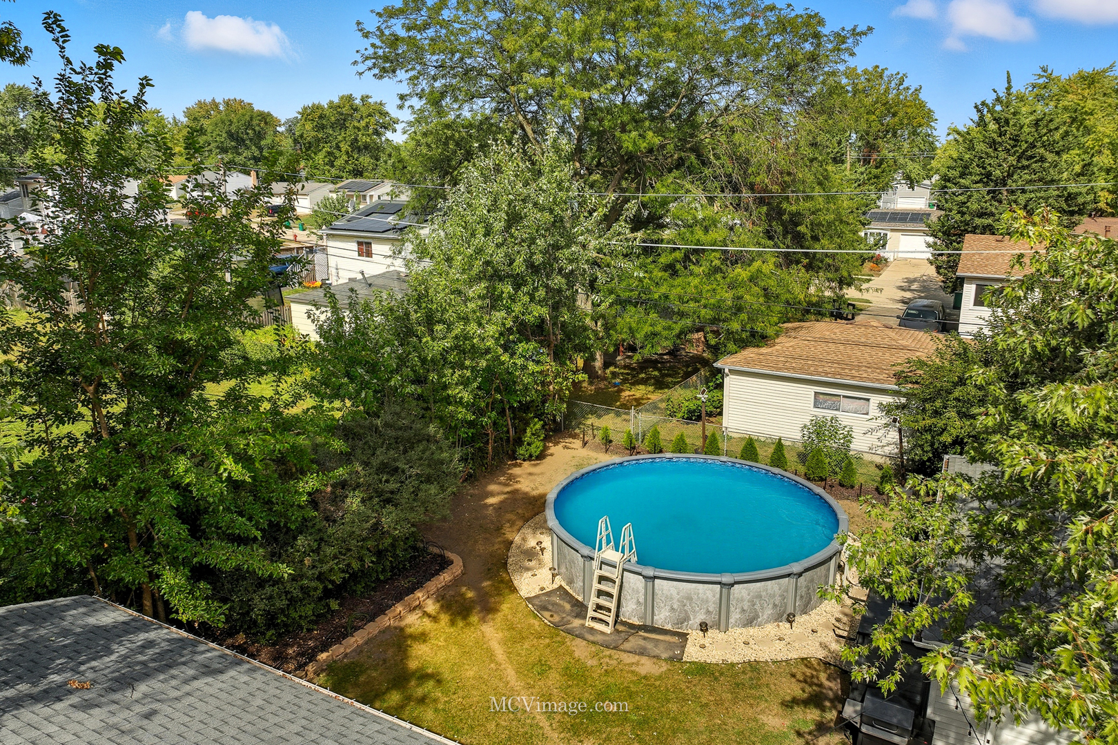 242 Tallman Avenue Romeoville, IL 60446 - Photo 6 of 25 a view of a swimming pool with an outdoor space and seating area