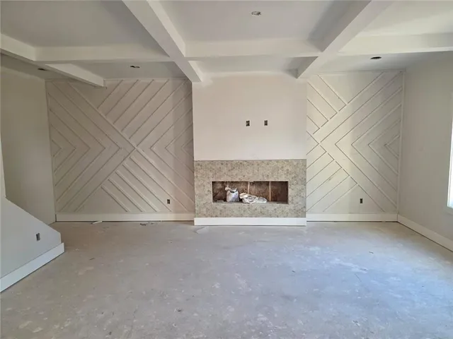an empty room with fireplace and windows