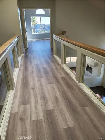 a view of a hallway view with wooden floor and staircase