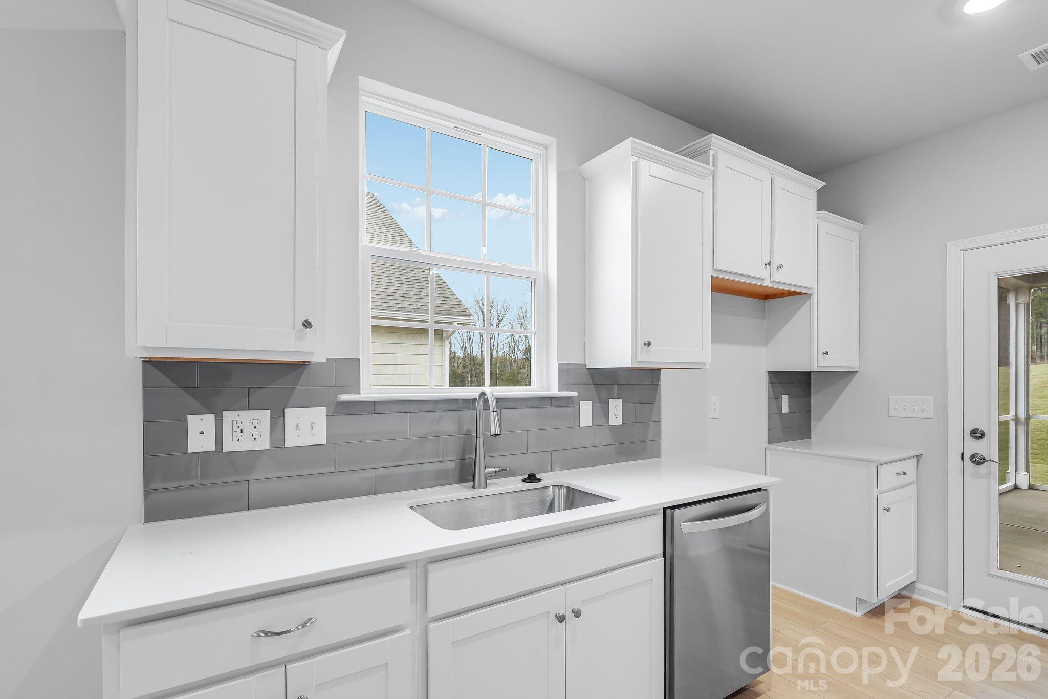 3308 Amarillo Court, Unit 344 Lancaster, SC 29720 - Photo 13 of 27 a kitchen with a sink dishwasher and cabinets