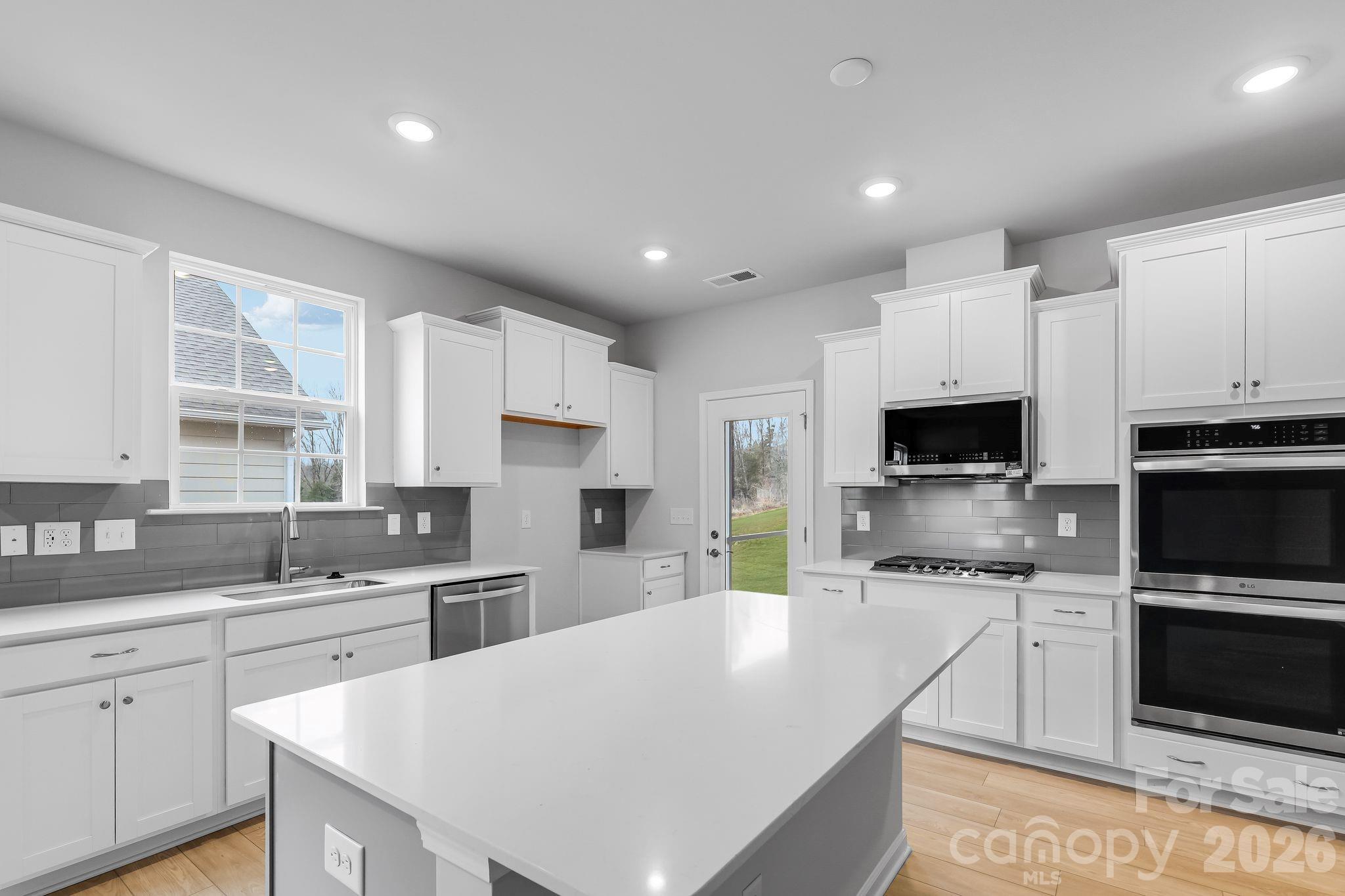 3308 Amarillo Court, Unit 344 Lancaster, SC 29720 - Photo 16 of 27 a kitchen with white cabinets and stainless steel appliances