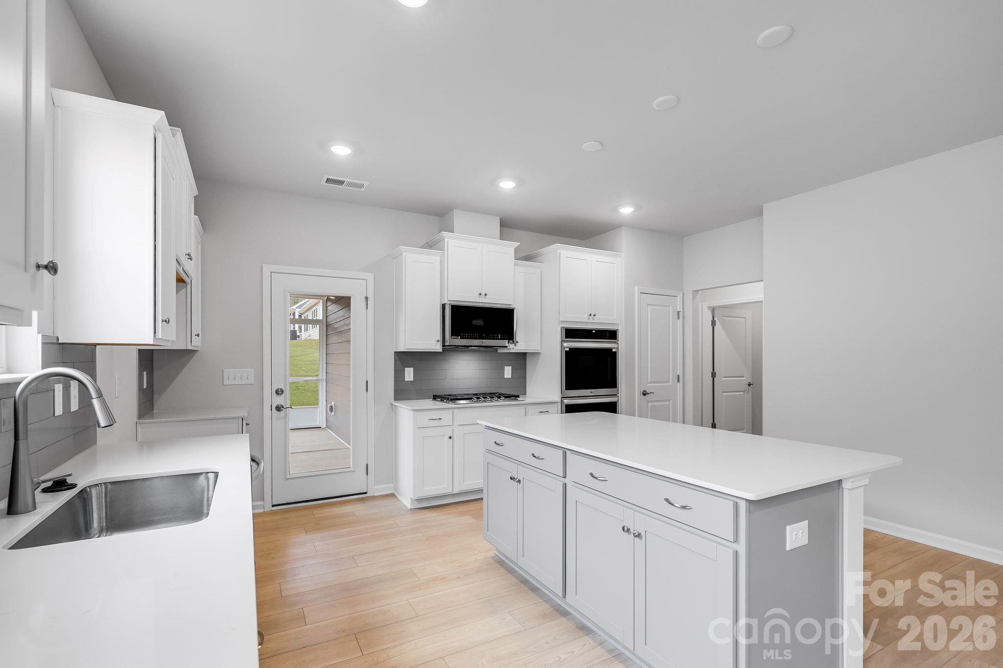3308 Amarillo Court, Unit 344 Lancaster, SC 29720 - Photo 17 of 27 a large kitchen with a large counter top stainless steel appliances and cabinets