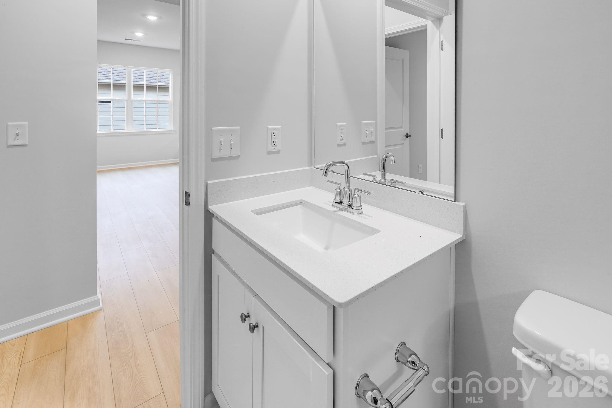 3308 Amarillo Court, Unit 344 Lancaster, SC 29720 - Photo 22 of 27 a bathroom with a sink a toilet and a mirror