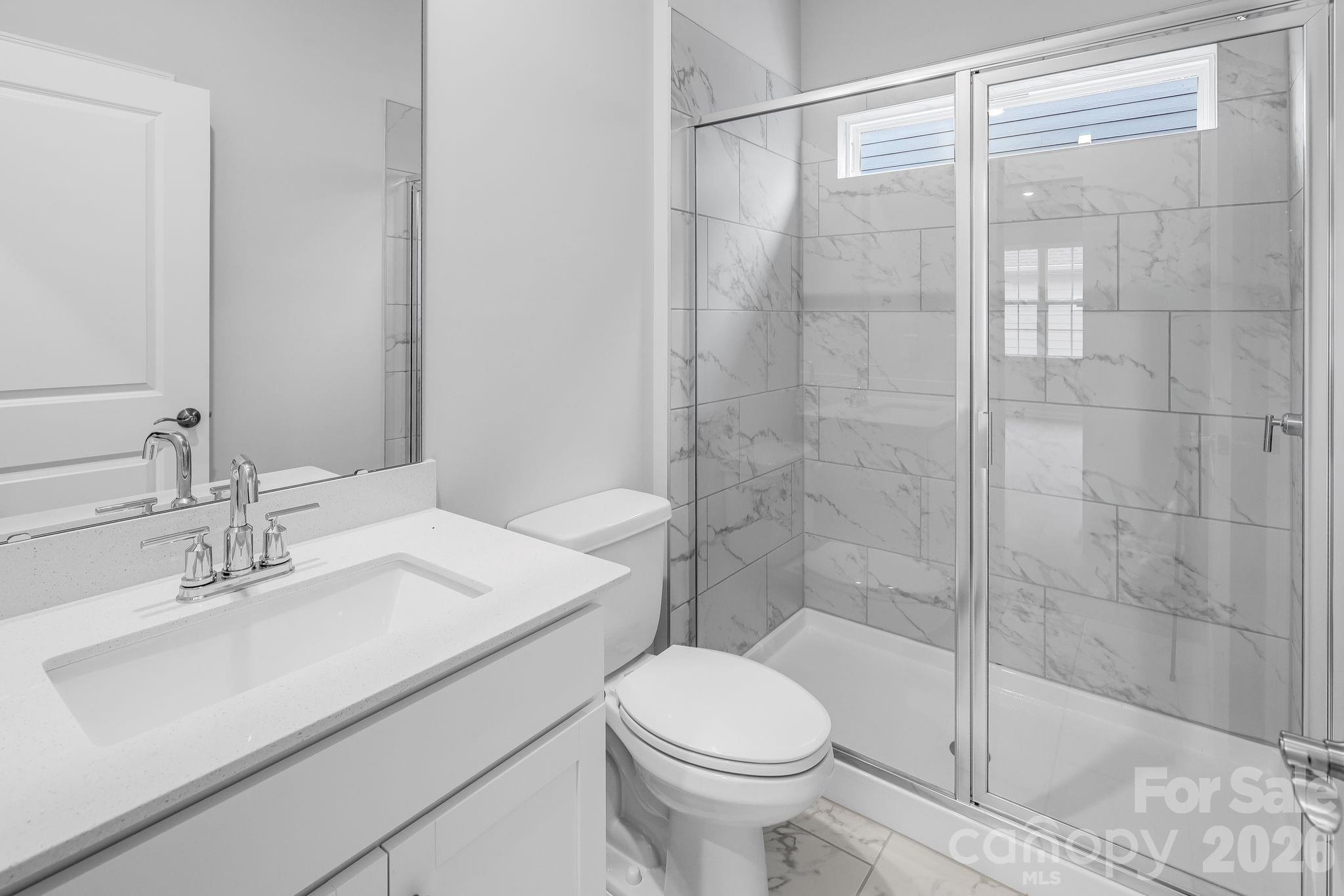 3308 Amarillo Court, Unit 344 Lancaster, SC 29720 - Photo 23 of 27 a bathroom with a sink toilet and shower