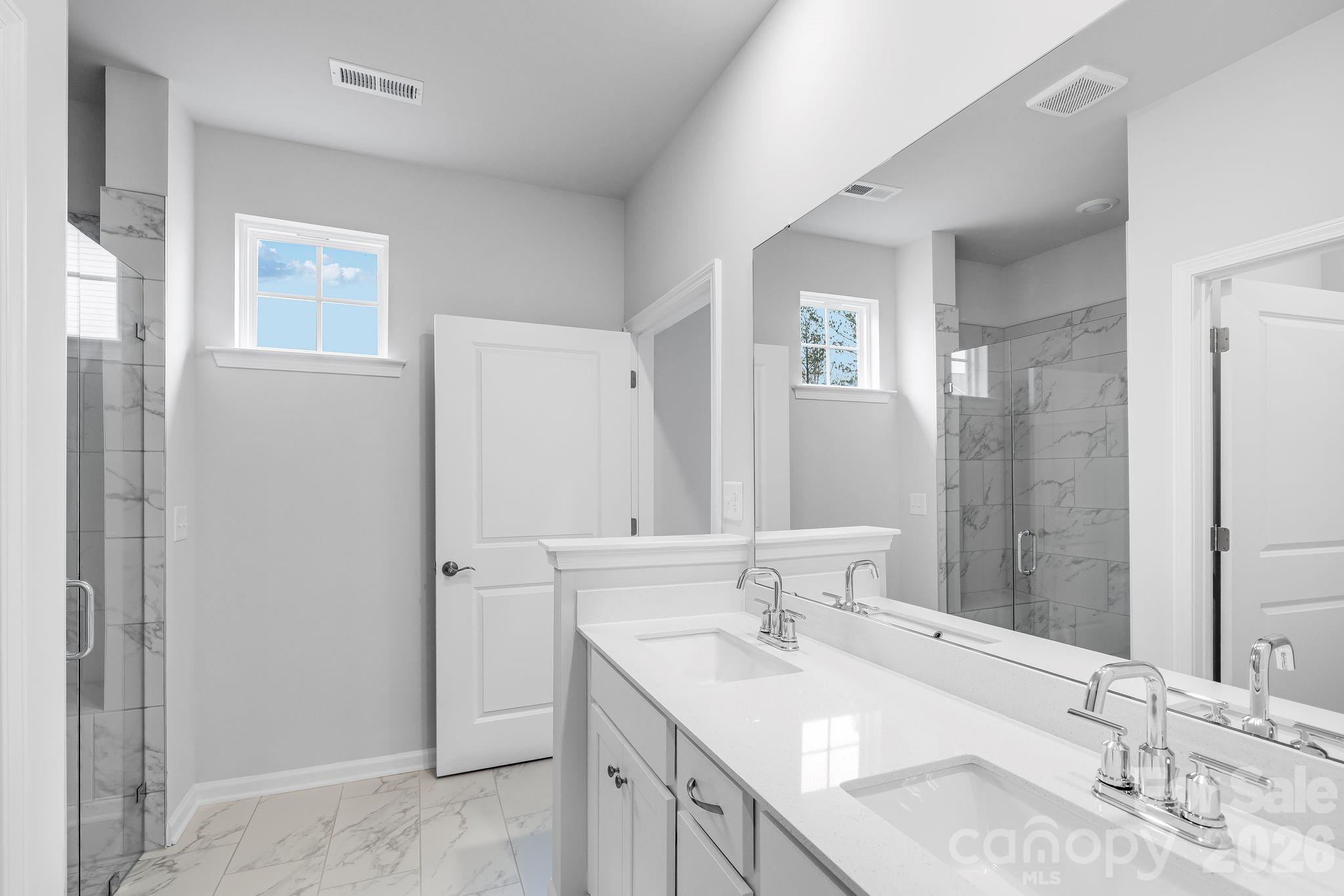 3308 Amarillo Court, Unit 344 Lancaster, SC 29720 - Photo 24 of 27 a bathroom with a granite countertop sink and a mirror