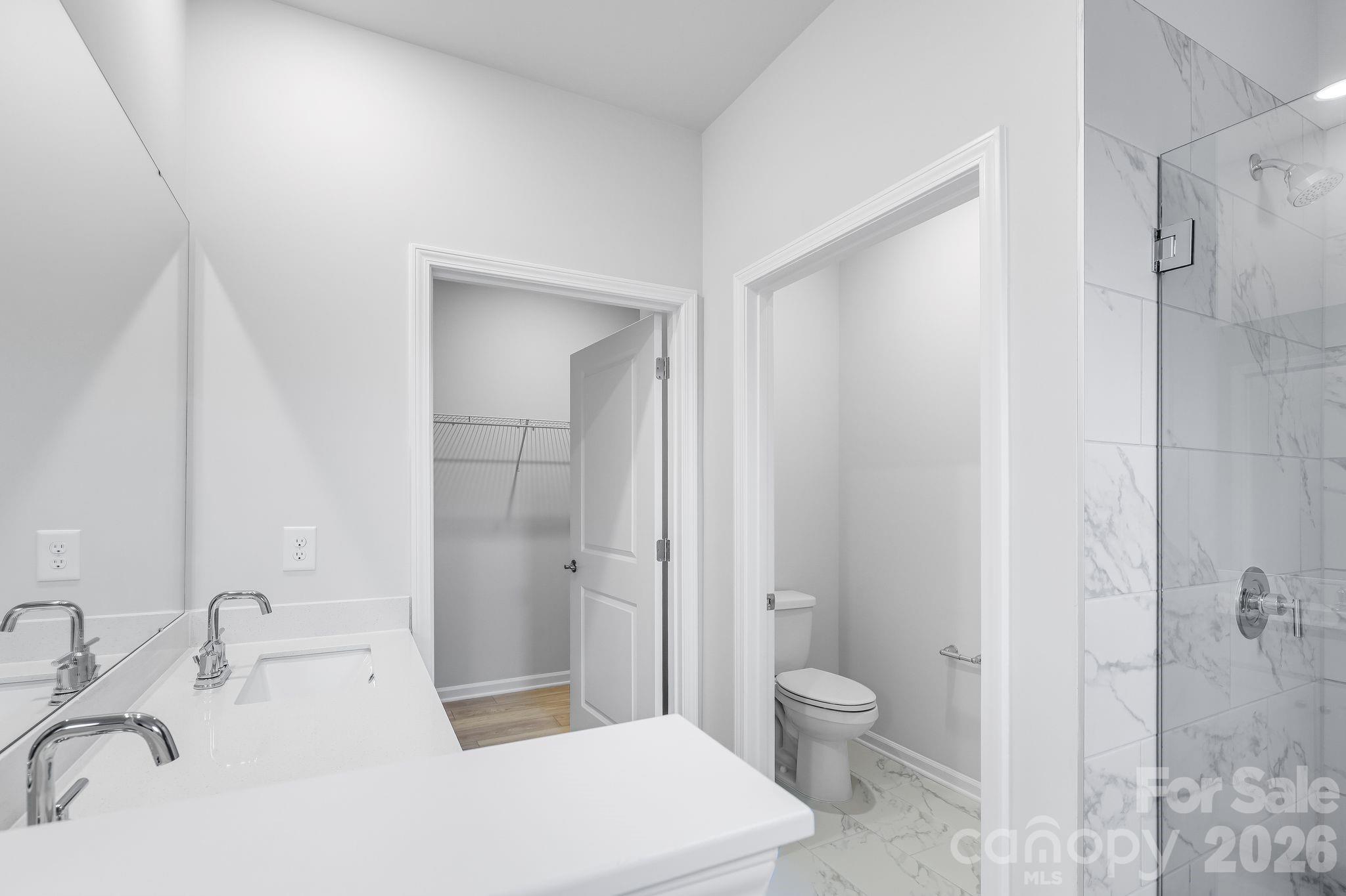 3308 Amarillo Court, Unit 344 Lancaster, SC 29720 - Photo 25 of 27 a bathroom with a sink a toilet and shower