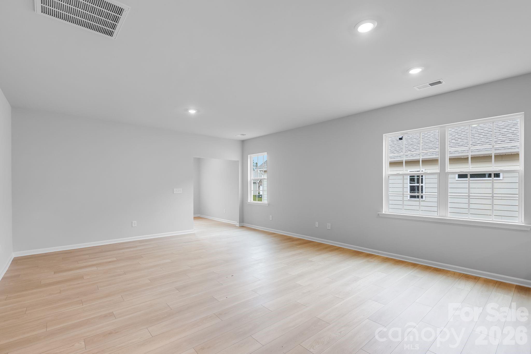 3308 Amarillo Court, Unit 344 Lancaster, SC 29720 - Photo 9 of 27 wooden floor in an empty room with a window