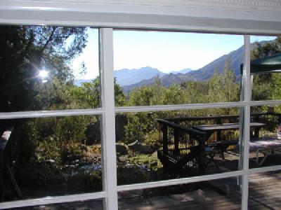 View from the living room which opens onto a large deck with the pond below.