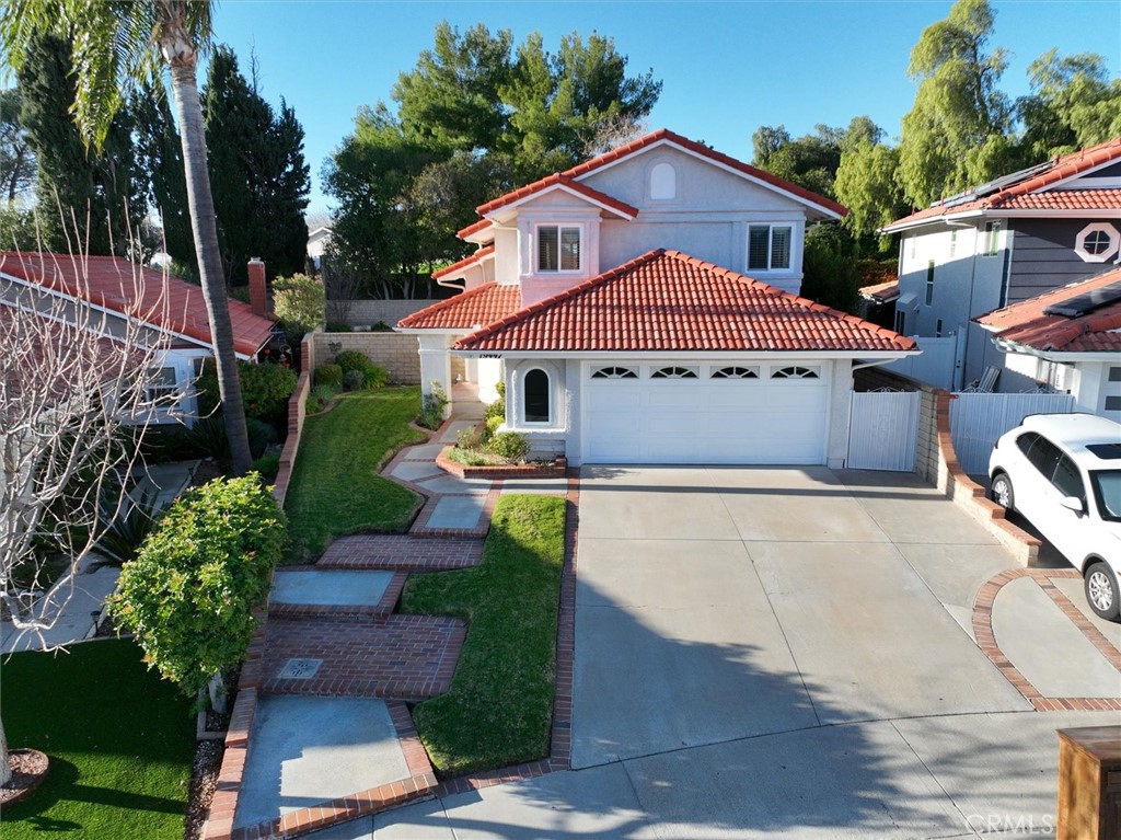 19447 Old Friend Road Canyon Country, CA 91351 - Photo 4 of 46 a front view of a house with a yard and garage