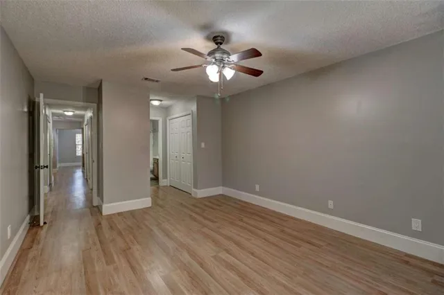 a view of an empty room with wooden floor