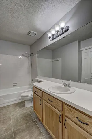 a bathroom with a sink a toilet and bathtub
