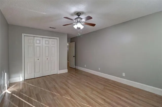 a view of an empty room with wooden floor