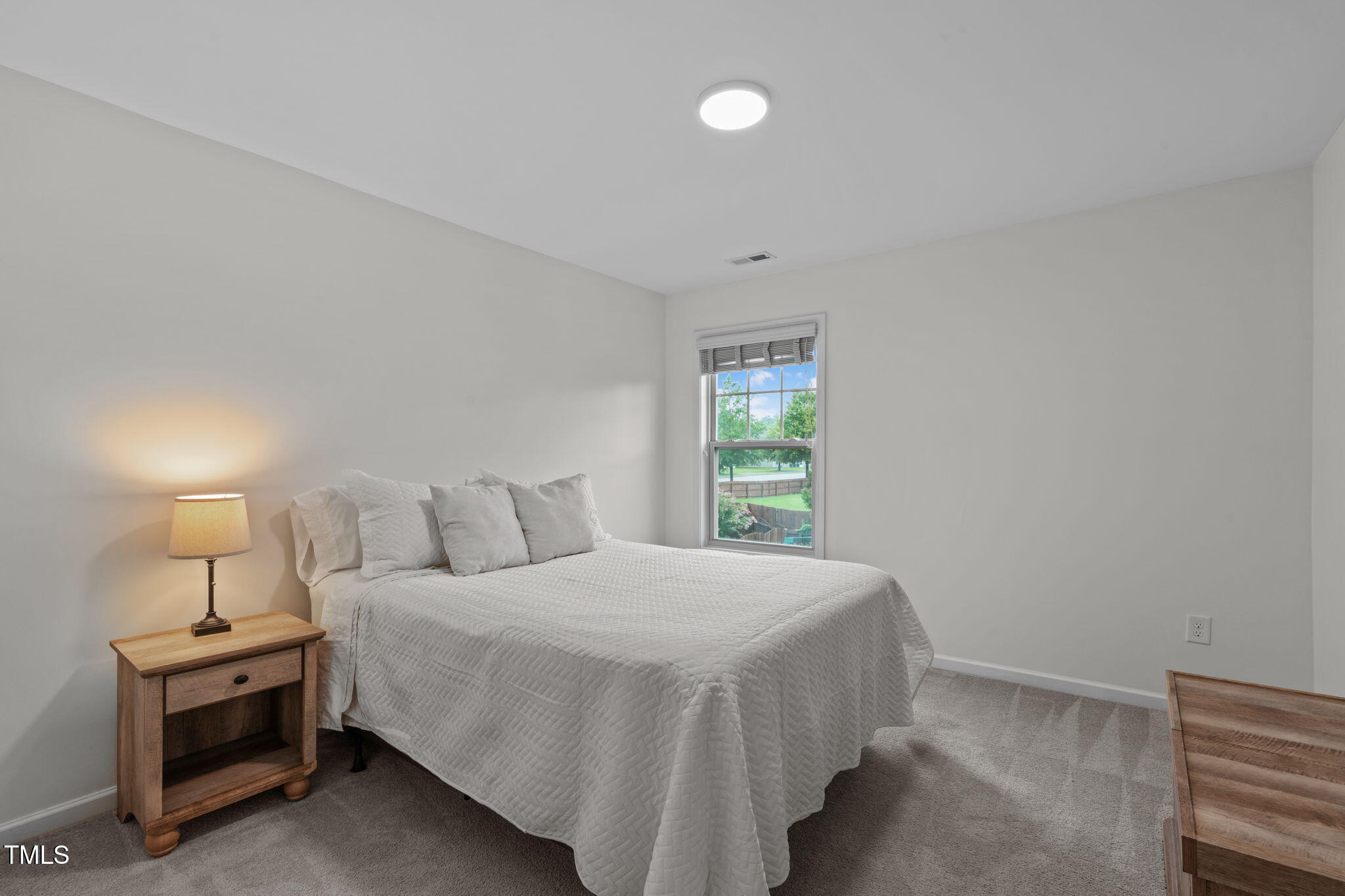 7605 Channery Way Raleigh, NC 27616 - Photo 23 of 33 a bedroom with a bed and a window