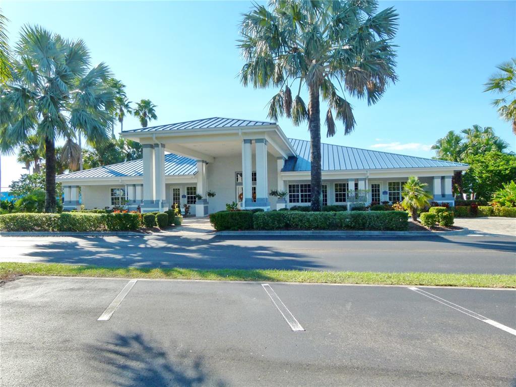 3520 Southwest 7th Manor, Unit 357 Okeechobee, FL 34974 - Photo 14 of 22 a front view of a house with swimming pool and porch