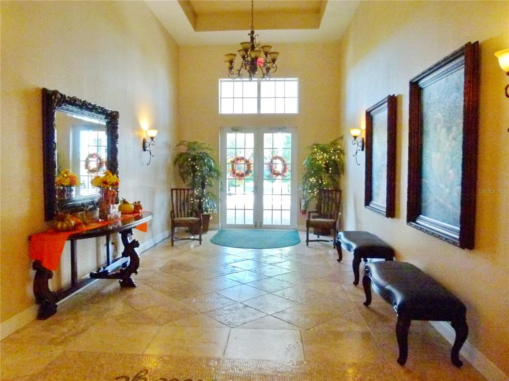 3520 Southwest 7th Manor, Unit 357 Okeechobee, FL 34974 - Photo 15 of 22 a living room with furniture and a chandelier