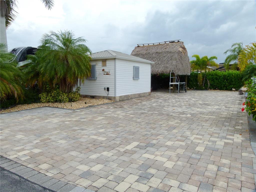 3520 Southwest 7th Manor, Unit 357 Okeechobee, FL 34974 - Photo 2 of 22 a view of a house with a yard and potted plants