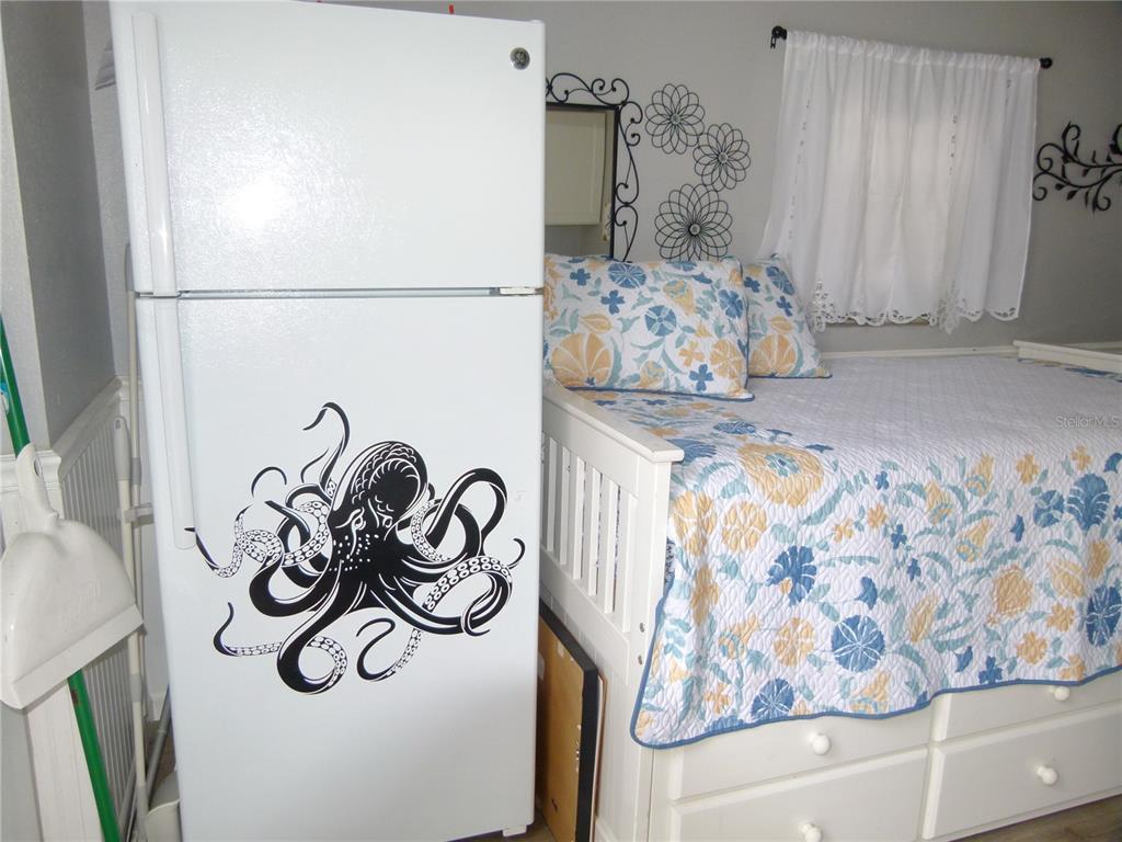 3520 Southwest 7th Manor, Unit 357 Okeechobee, FL 34974 - Photo 3 of 22 a bedroom with a bed and cabinets