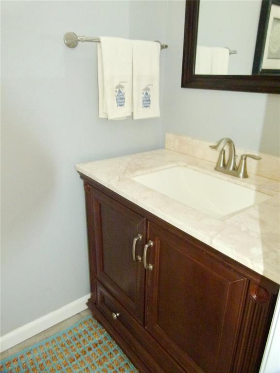 3520 Southwest 7th Manor, Unit 357 Okeechobee, FL 34974 - Photo 6 of 22 a bathroom with a sink a vanity and a mirror