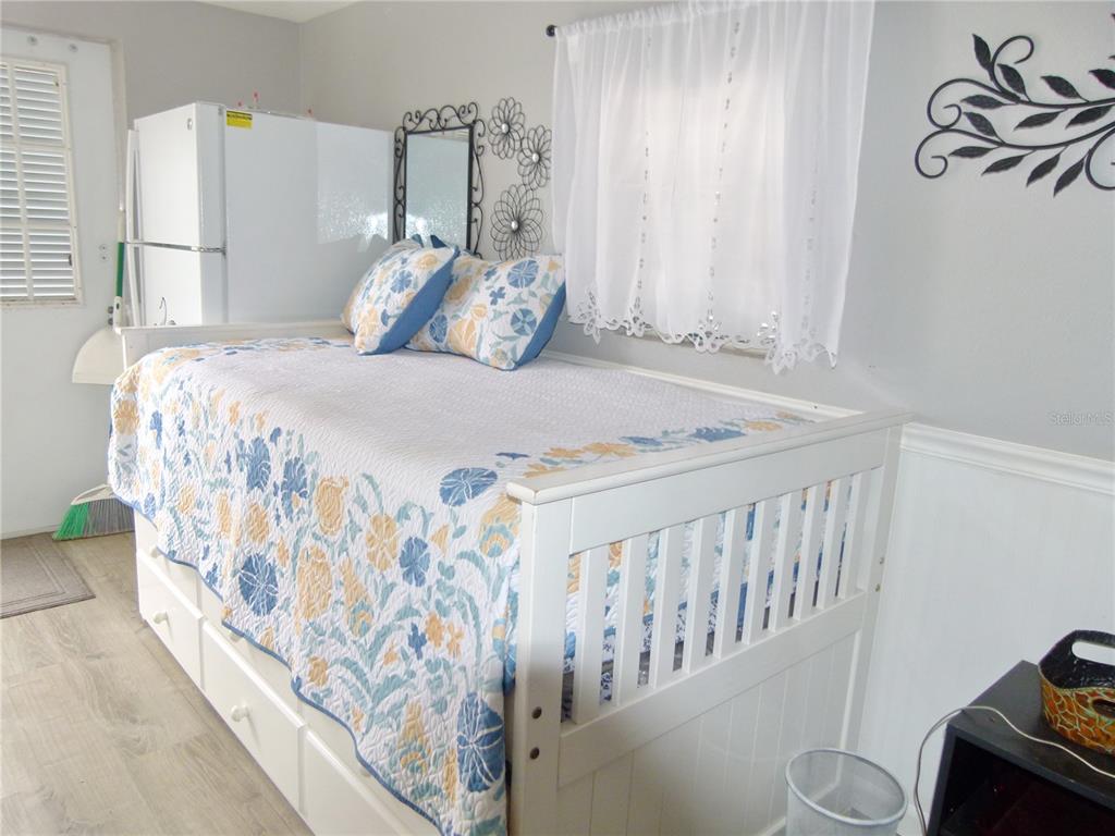 3520 Southwest 7th Manor, Unit 357 Okeechobee, FL 34974 - Photo 8 of 22 a bedroom with a bed and a window