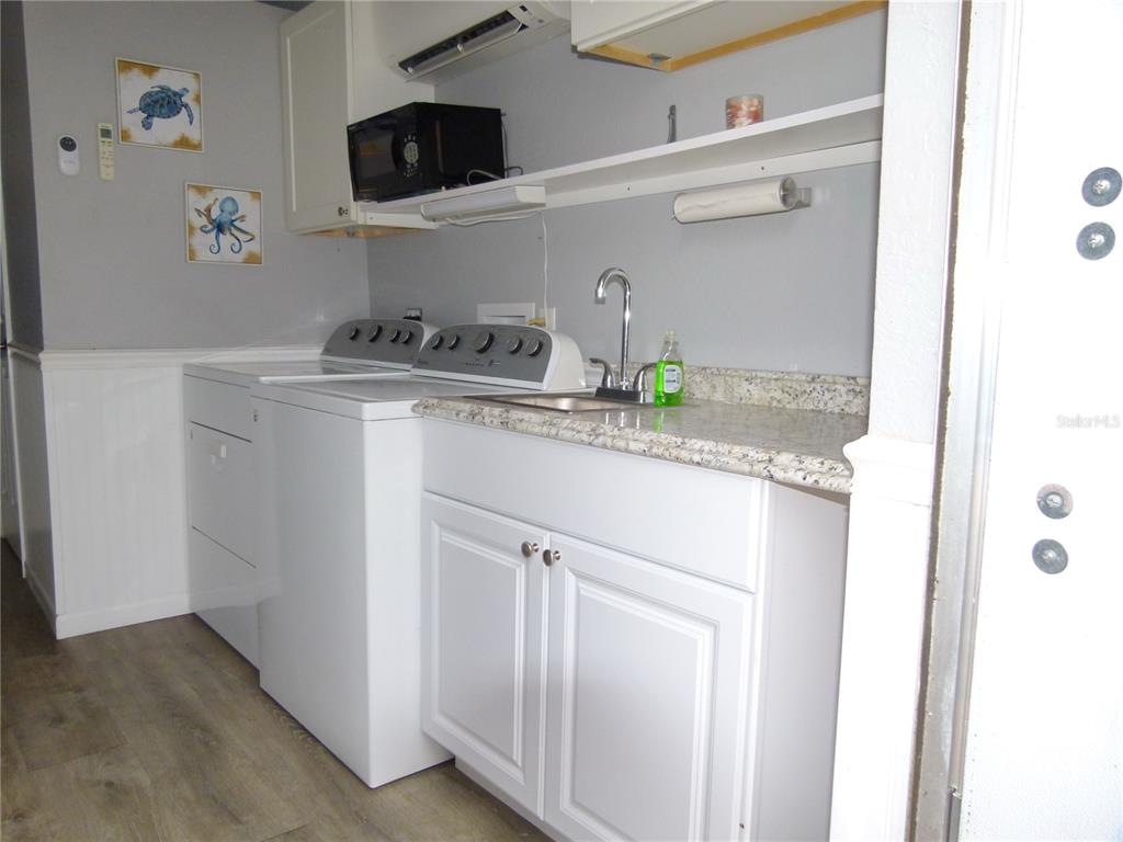 3520 Southwest 7th Manor, Unit 357 Okeechobee, FL 34974 - Photo 9 of 22 a kitchen with a sink a stove and cabinets