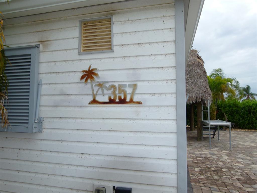 3520 Southwest 7th Manor, Unit 357 Okeechobee, FL 34974 - Photo 10 of 22 a view of a door and chair in the patio