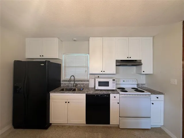 a kitchen with cabinets and appliances