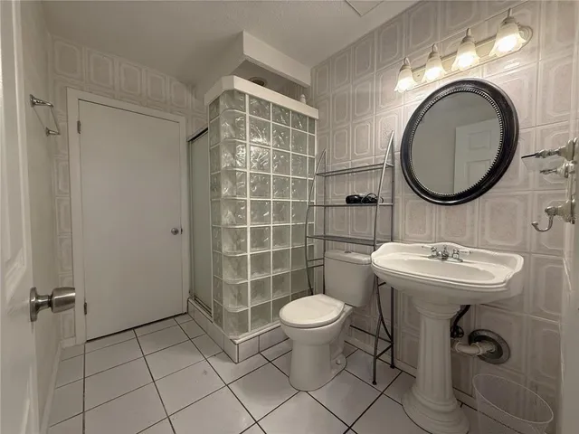 a bathroom with a sink toilet and a mirror