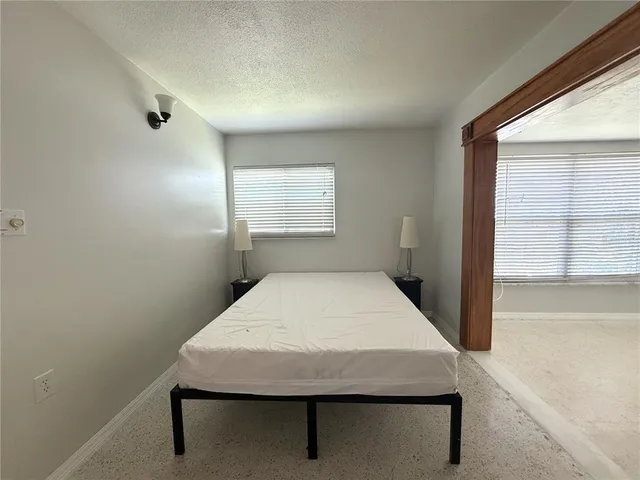 a room with pool table and windows