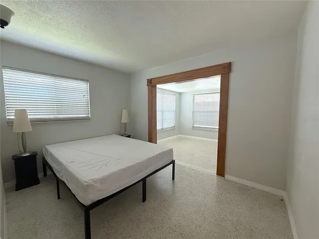 a room that has a bed and a table in it