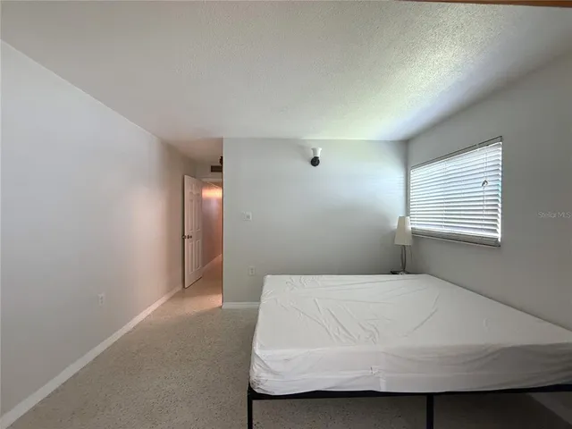 a bedroom with a bed and window