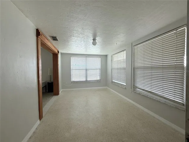 a view of an empty room with a window