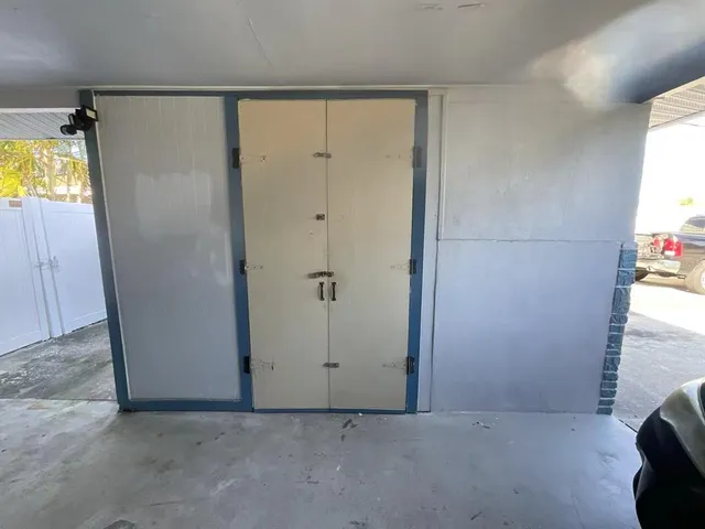 a view of empty room with window and ceiling fan