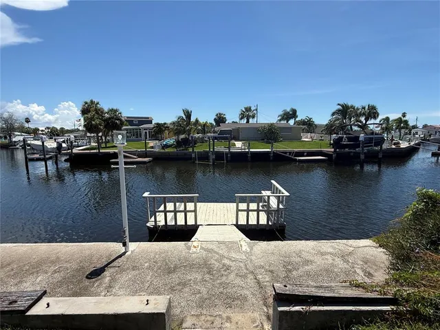 a view of a lake with boats and trees in the background