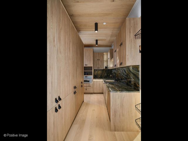 a kitchen with sink a stove and cabinets
