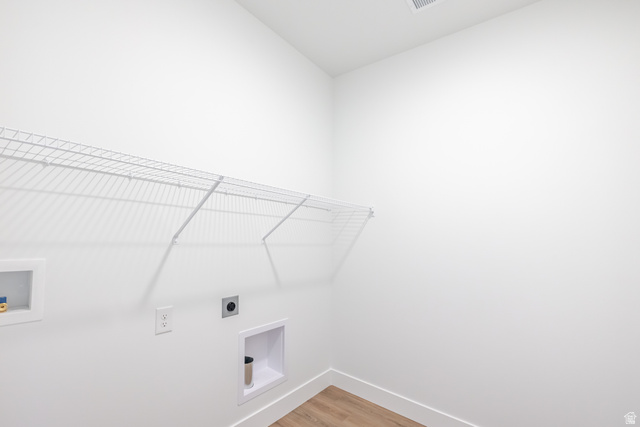 4664 South 680th West, Unit S201 Mapleton, UT 84664 - Photo 5 of 16 Dedicated laundry area with white wire shelving, utility hookups, and wood-finish flooring