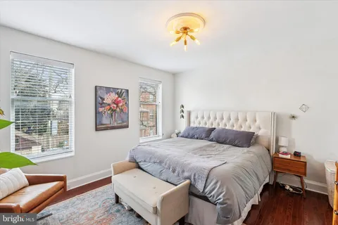 a bedroom with a bed and a couch